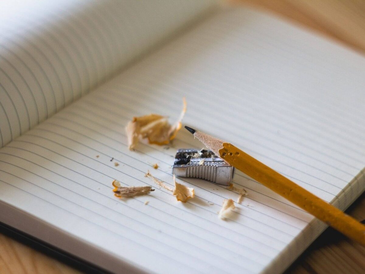 Lessons from Therapy Notes - Pencil, pencil shavings, and pencil sharpener on a white lined notebook
